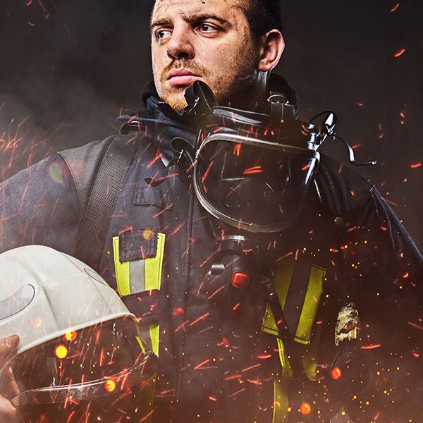 a-firefighter-dressed-in-a-uniform-in-a-studio-EHBRNVE