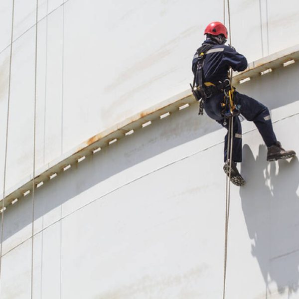 stock-photo-male-worker-rope-access-inspection-thickness-white-storage-tank-shadow